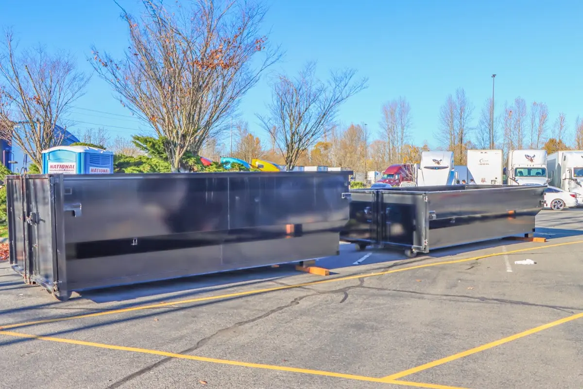 Professional dumpster rental service with roll-off container on residential driveway in Black Diamond